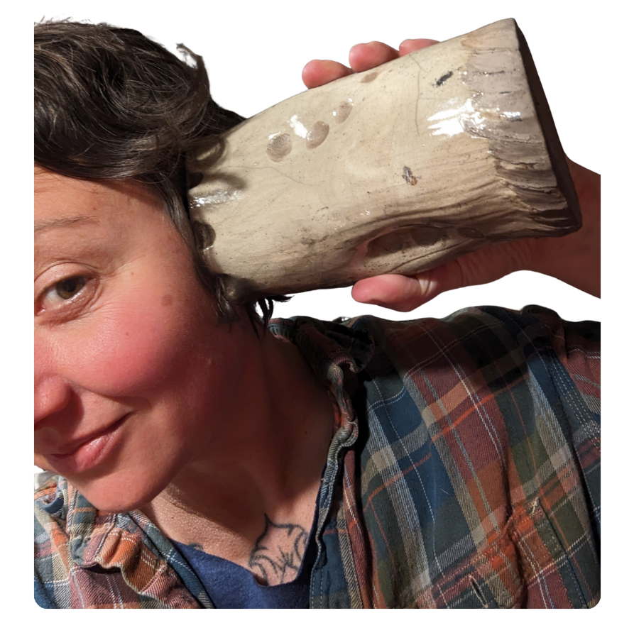 image of artist Rachel Tayse holding a ceramic vase to her ear