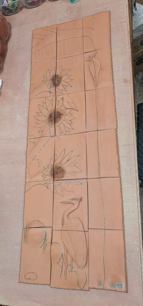 wax outlines on bird and flower tile sculpture