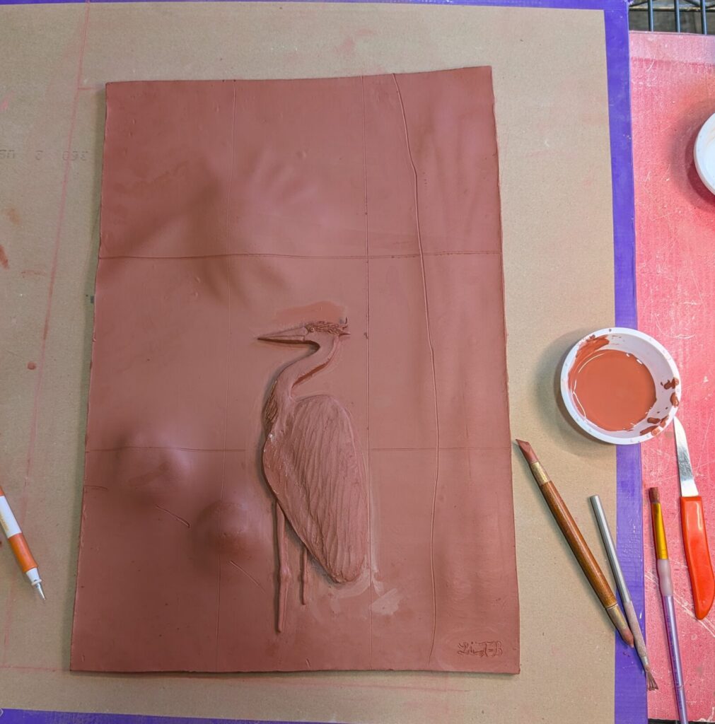 red clay sculpted heron