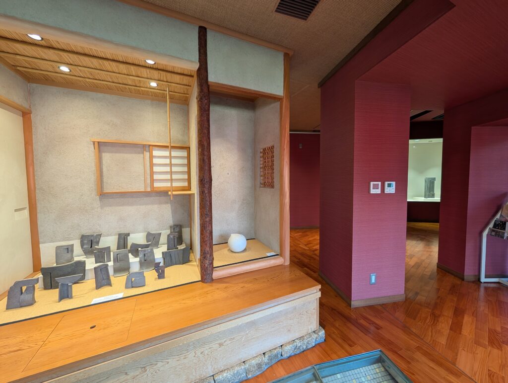 small black studies exhibited in a room-like structure