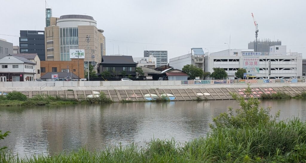 view of tajimi japan over the toki river showing off the mosaics on the erosion control walls