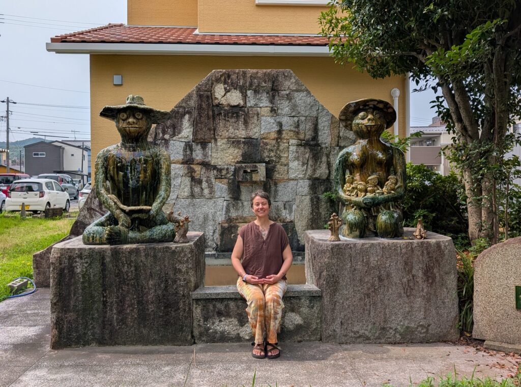 ten foot tall ceramic unagappa character statues surrounding a fountain